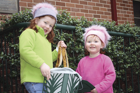 Two Goulburn girls demonstrate how to use the MaxAir bins and Biobags.