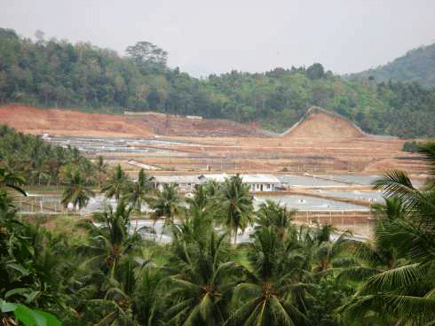 Intensive shrimp farm in Sumatra. Hillside soils have been excavated to build dykes for the ponds and canals. Exposed soil can erode during the wet season, leading to sedimentation of coral reefs.