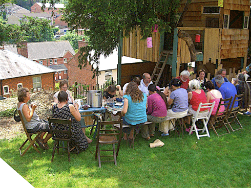 Sharing a meal at Springhill Cohousing, Gloucestershire, UK. Springhill comprises 35 homes, ranging from five-bedroom houses to one-bedroom flats. It was completed in 2006 and was the first new-build cohousing scheme to be finished in the UK.