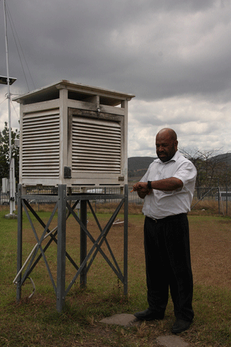 Mr Kasis Inape checks weather recording instruments at the Papua New Guinea National Weather Service Office in Port Moresby.