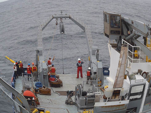 Members of the T-TIDE team recovering a mooring during a previous expedition.