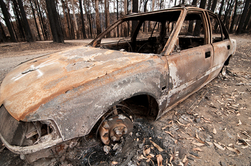 A burnt-out car at Kinglake after 2009’s Black Saturday fires in Victoria: whether residents in fire-prone areas plan to leave early or stay and defend, a reliable and adaptable bushfire survival plan is a must.
